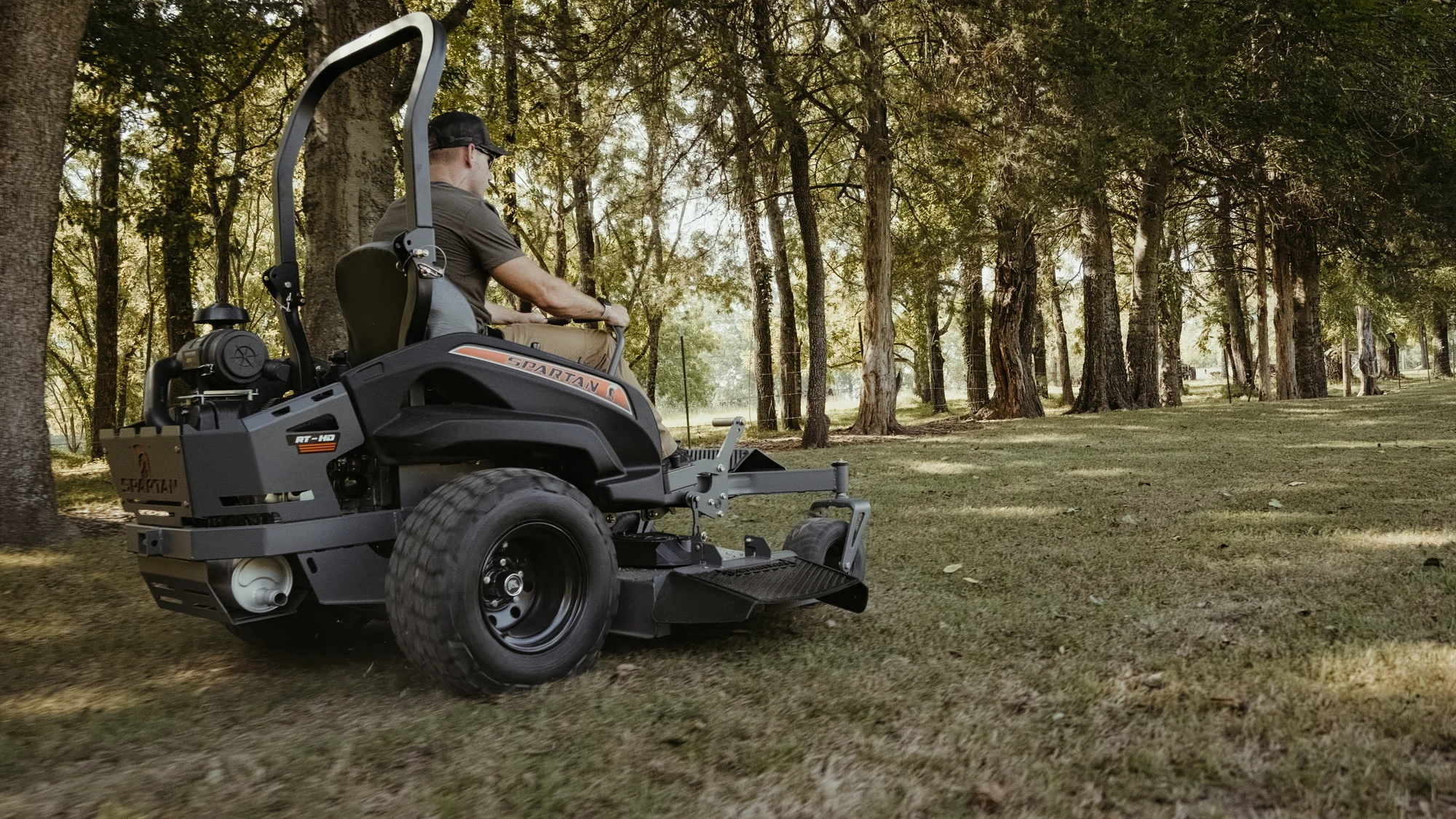 Spartan Rt Hd Zero Turn Rider Rsrhd154999Kx Back View Left Man Cutting Grass product image