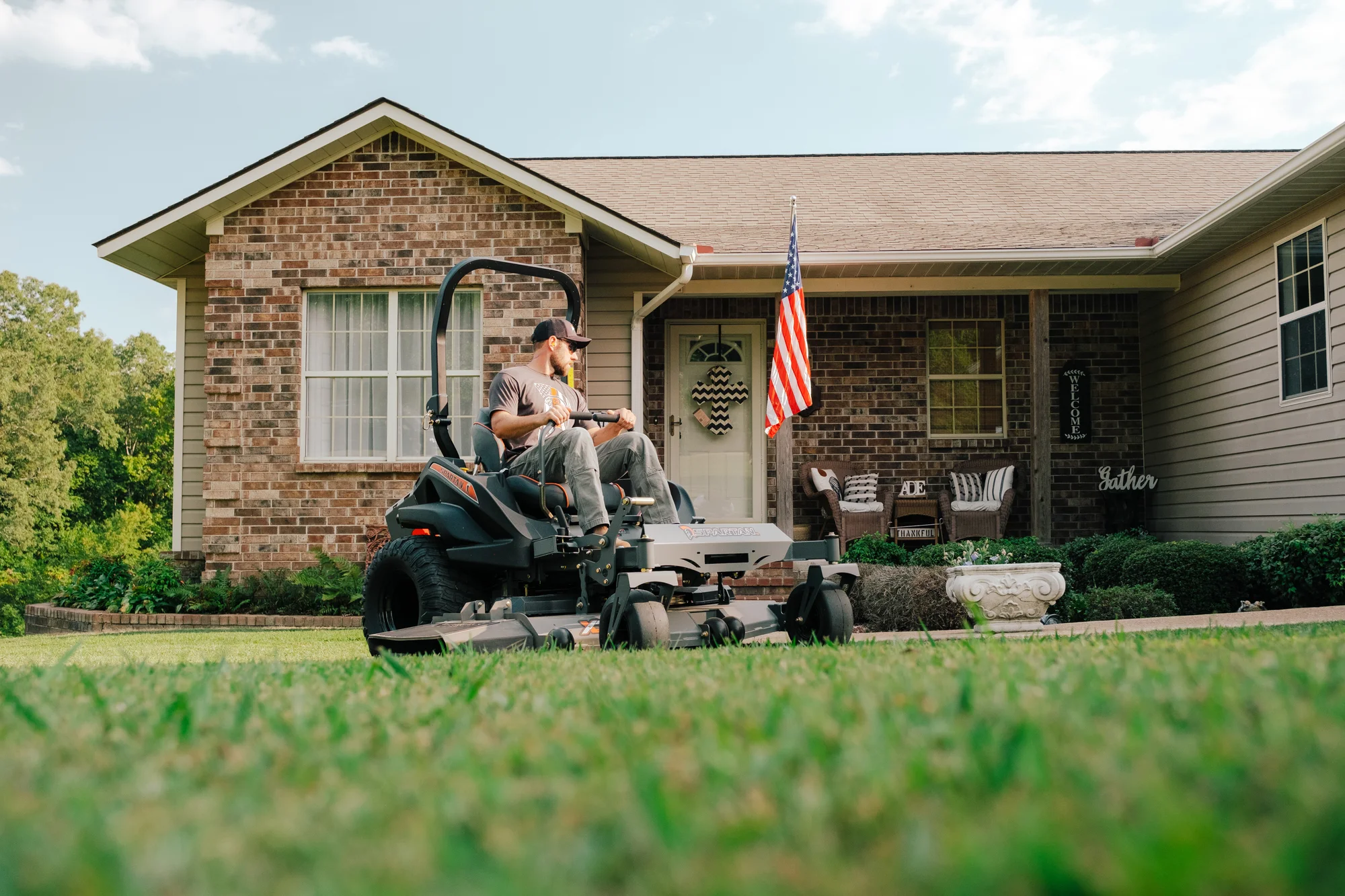 Spartan RZ-HD Zero Turn Rider RSZL115427CXI Spartan Rz Hd Zero Turn Rider Rszl115427Cxi Wide Angle Man Cutting Grass House product image