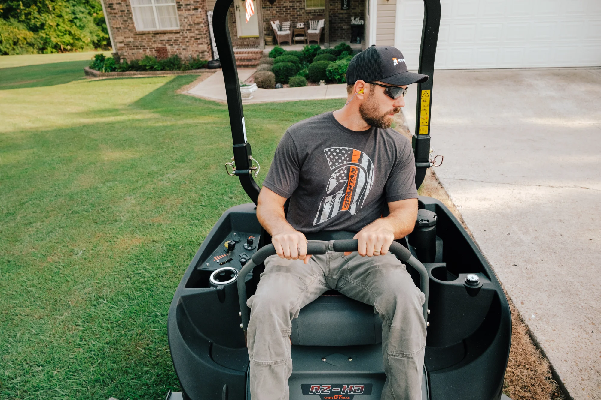Spartan RZ-HD Zero Turn Rider RSZL116027CXI Spartan Rz Hd Zero Turn Rider Rszl116027Cxi Man Posing Mower Closeup product image
