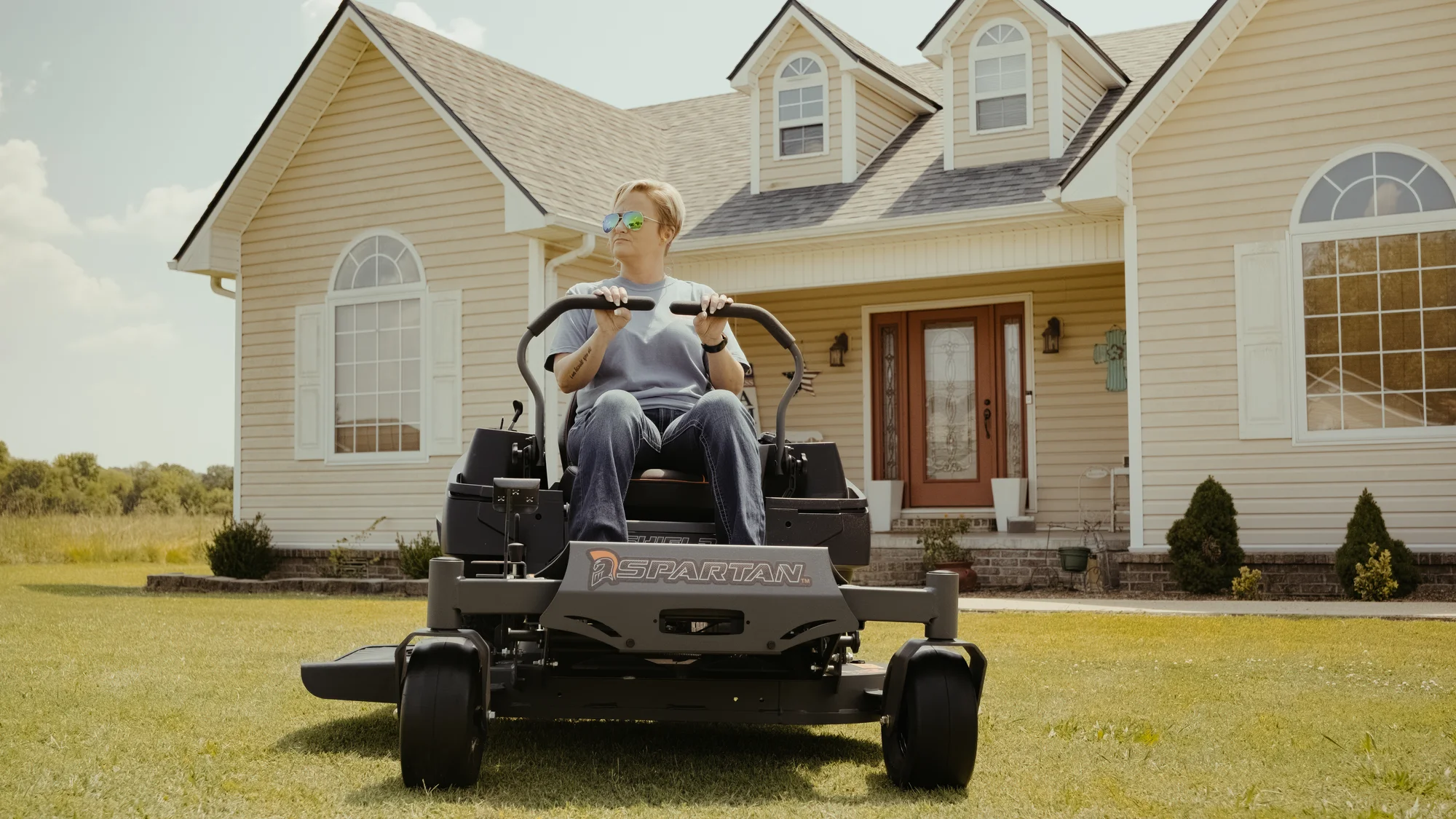 Spartan Shield HD Zero Turn Rider SZSD1K42691KR Spartan Shield Hd Zero Turn Rider Szsd1K42691Kr Woman On Mower House Front View product image