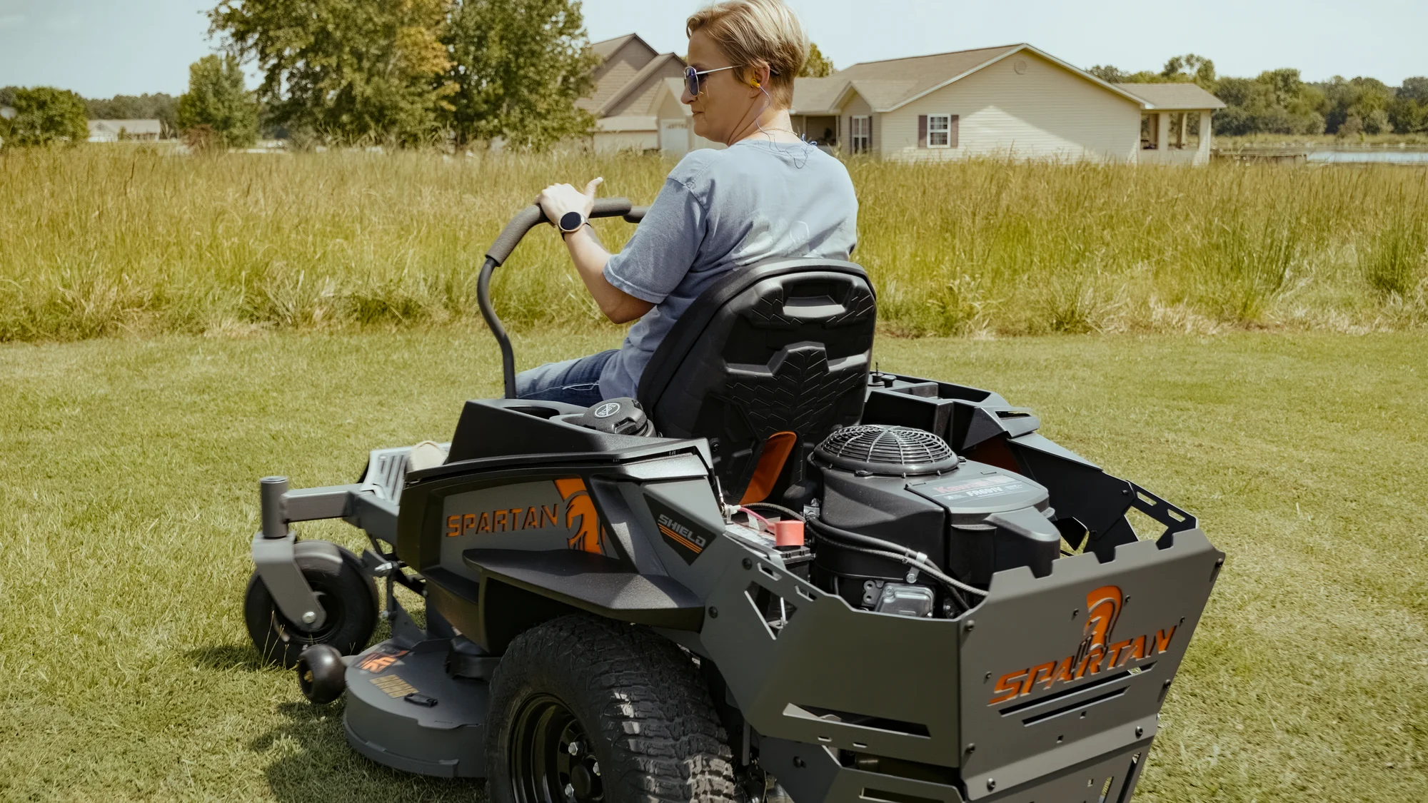 Spartan Shield Zero Turn Rider SZSH1K42691KR Spartan Shield Zero Turn Rider Szsh1K42691Kr Woman On Mower Back View product image