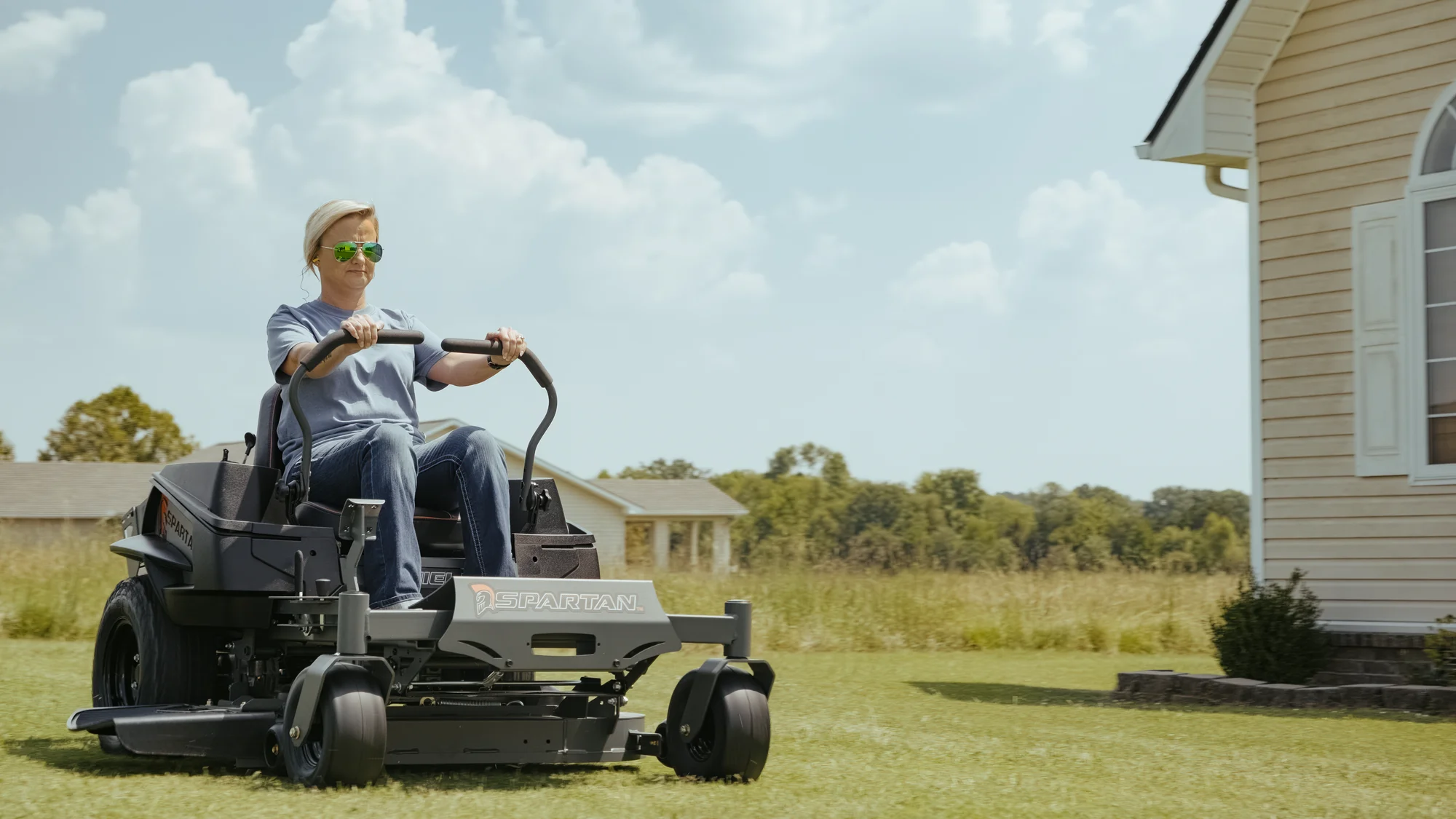 Spartan Shield Zero Turn Rider SZSH1K54722SE Spartan Shield Zero Turn Rider Szsh1K54722Se Woman On Mower House Wide Angle product image