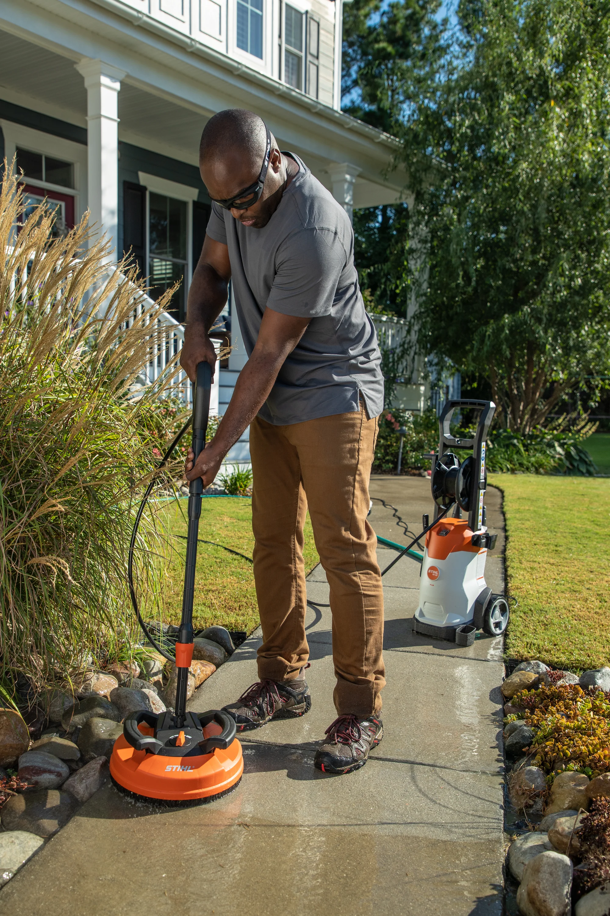 Stihl Re Series Pressure Washer Re 90 Plus Man Cleaning Sidewalk product image