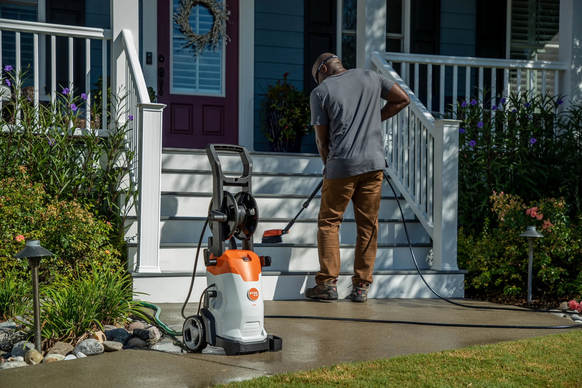 Stihl Re Series Pressure Washer Re 90 Plus Man Cleaning Stairs product image