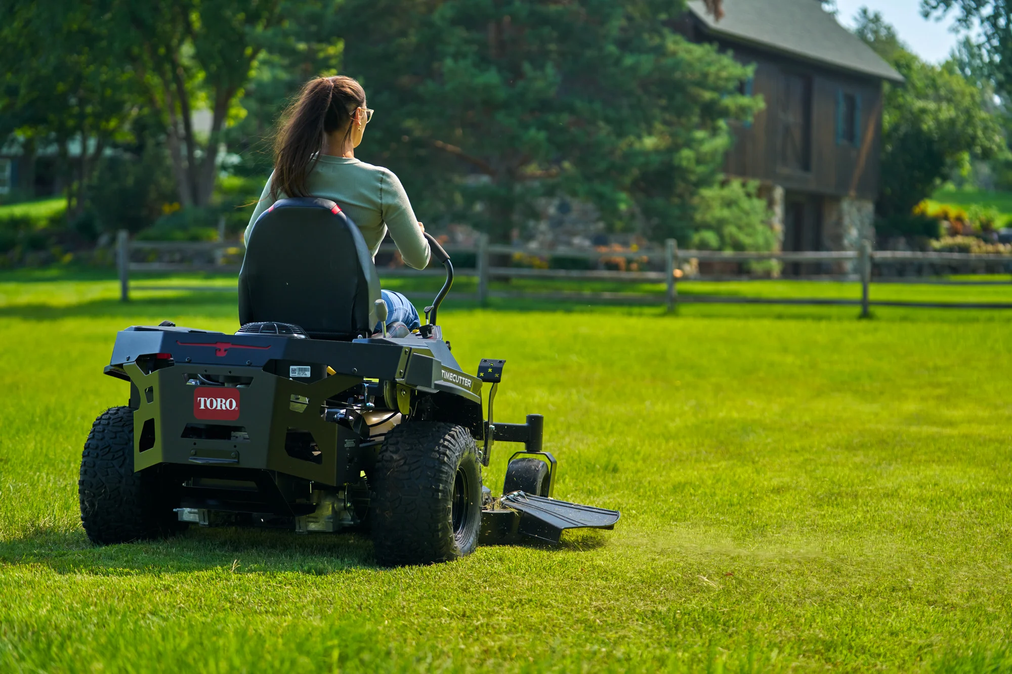 Toro Timecutter Max Havoc Myride Series Zero Turn Rider 77507 Woman Cutting Grass Back View product image