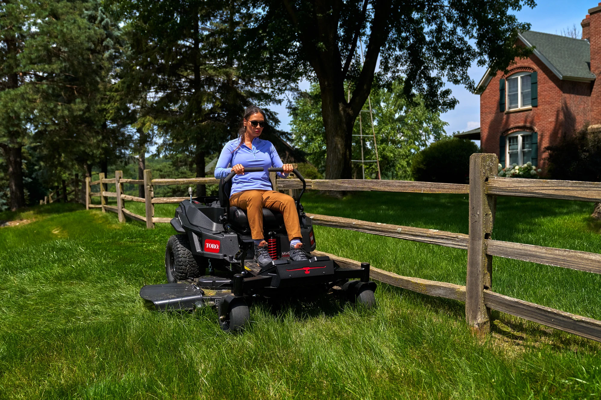 Toro Timecutter Max Havoc Myride Series Zero Turn Rider 77507 Woman Mowing By Fence Closeup product image