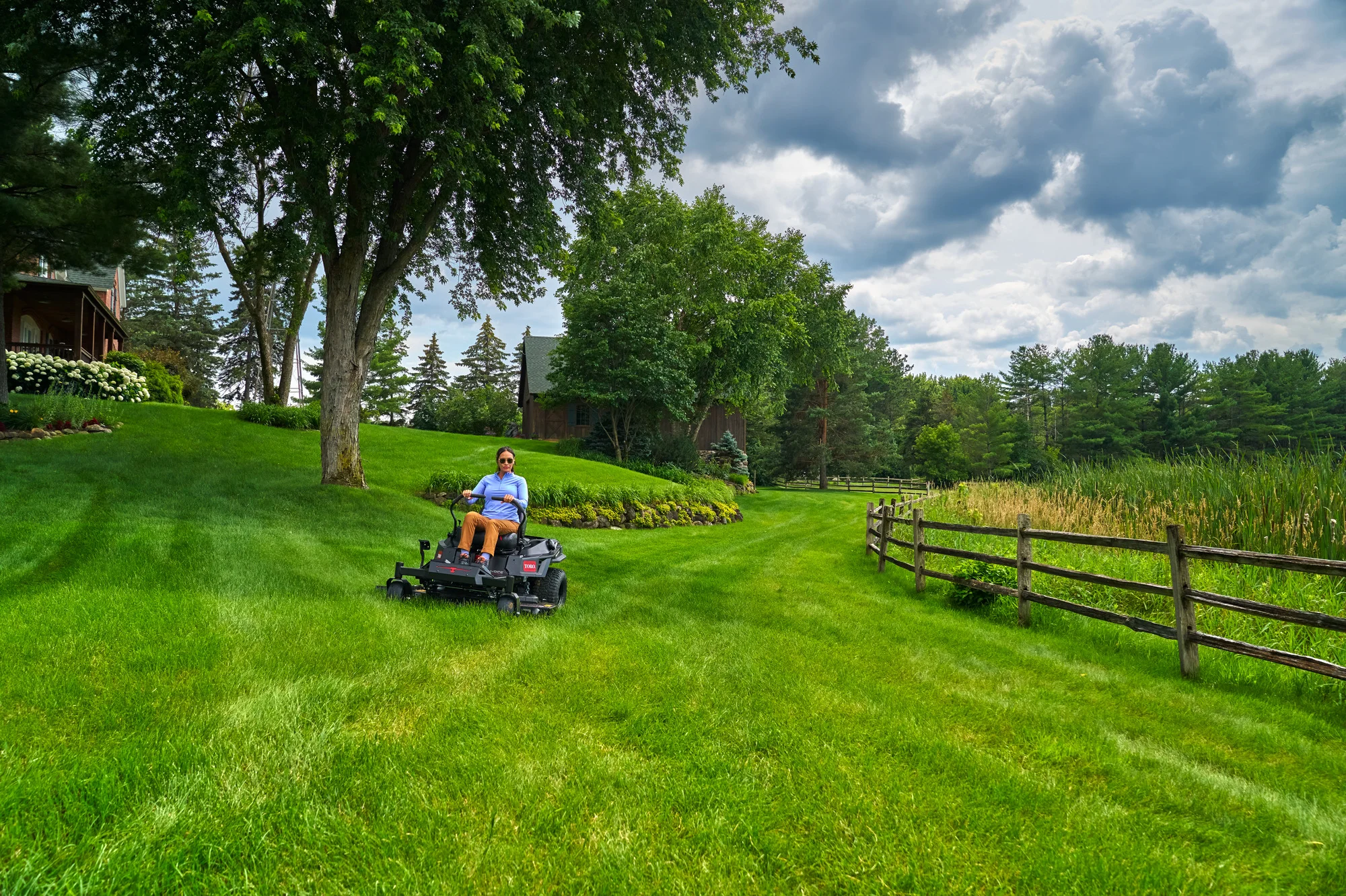 Toro Timecutter Max Havoc Myride Series Zero Turn Rider 77507 Woman Mowing By Fence Distant product image