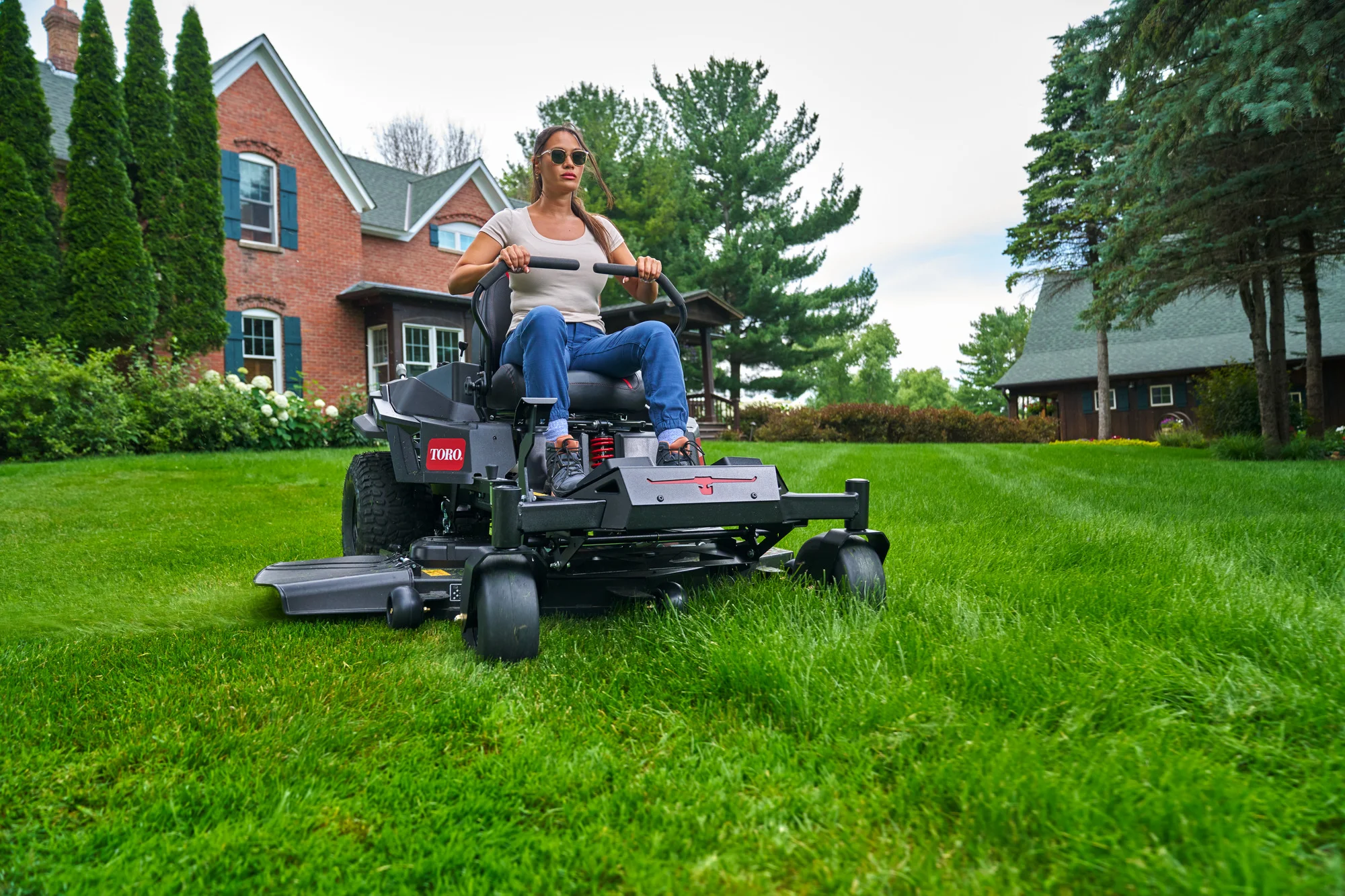 Toro Timecutter Max Havoc Myride Series Zero Turn Rider 77507 Woman Mowing Lawn Wide Angle product image