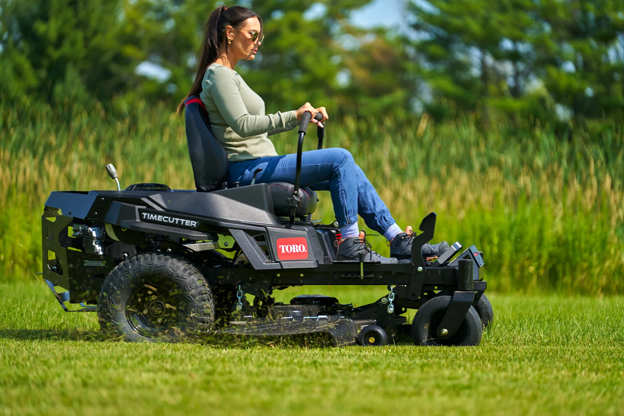 Toro Timecutter Max Havoc Myride Series Zero Turn Rider 77507 Woman Mowing Side View product image