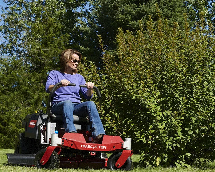 Toro Timecutter Series Zero Turn Rider 77401 Woman Mowing Bush product image
