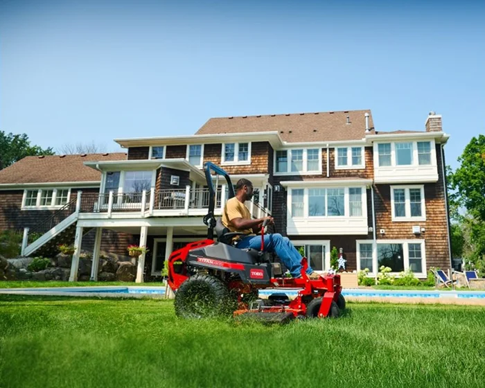 Toro Titan Max Series Zero Turn Rider 76606 Man Mowing By House product image