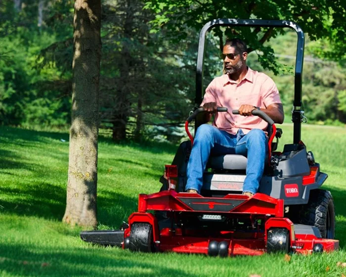 Toro Titan Max Series Zero Turn Rider 76606 Toro Titan Max Series Zero Turn Rider 76606 Man Mowing By Tree product image