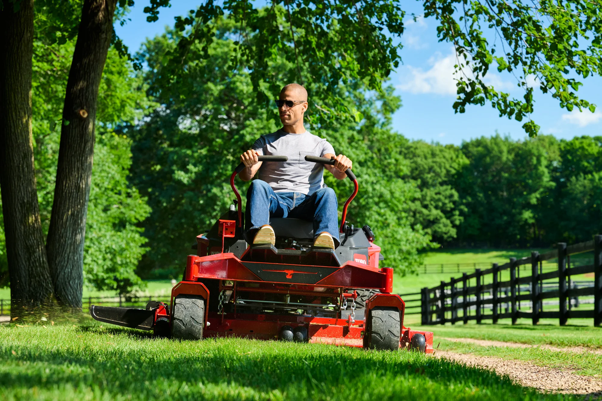 Toro Titan Series Zero Turn Rider 76614 Toro Titan Series 76614 Man Mowing Trees product image