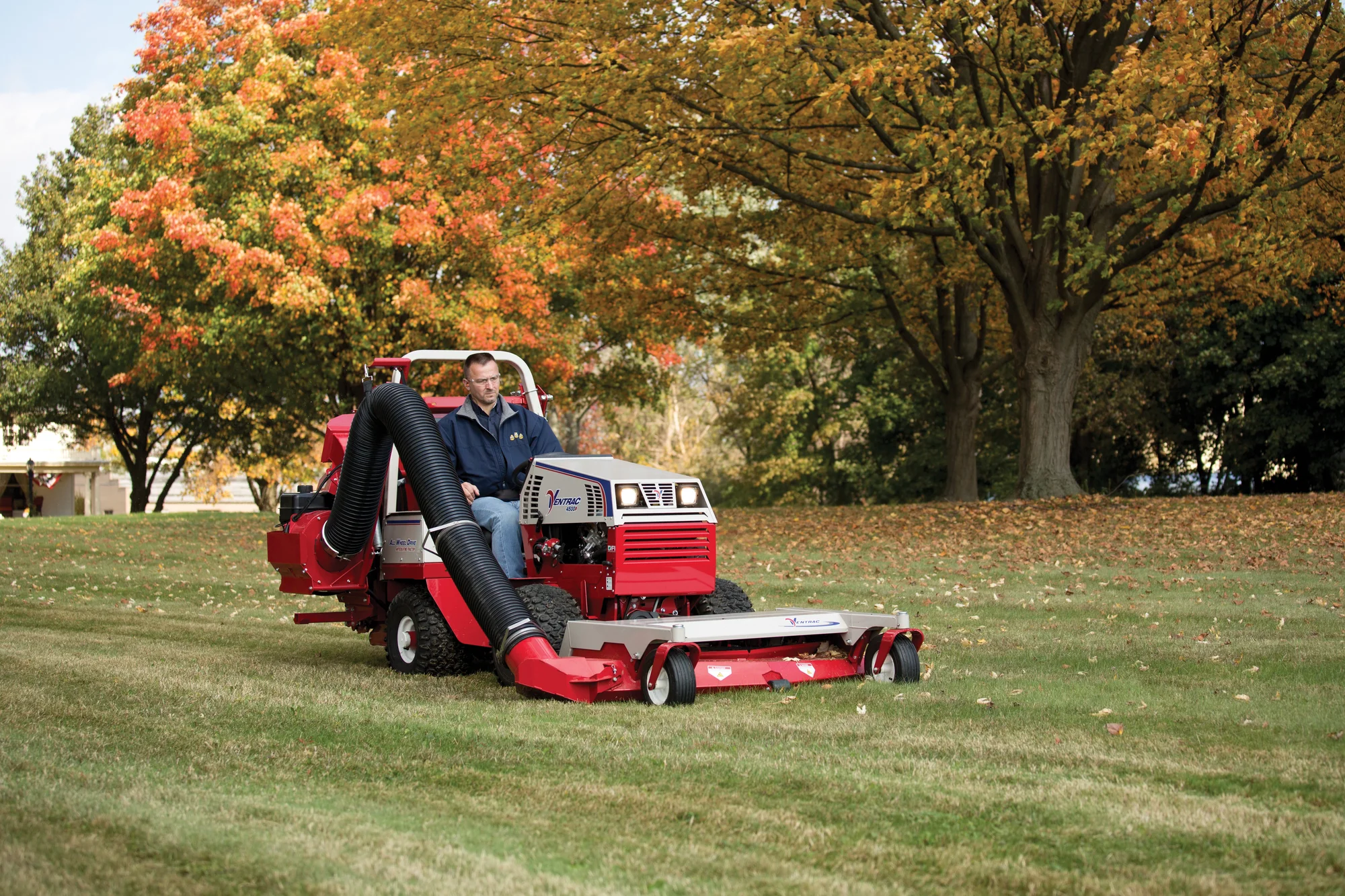 Ventrac P Series Compact Utility Tractors 4500P Front View Left Mowing And Vacuum In Use product image