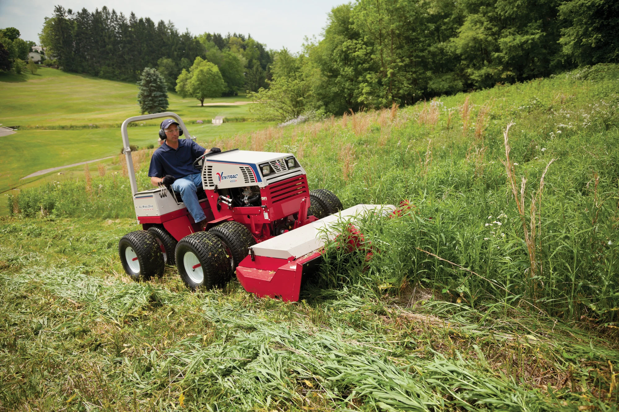 Ventrac P Series Compact Utility Tractors 4500P Side View Left Mower Deck Cutting Tall Grass product image