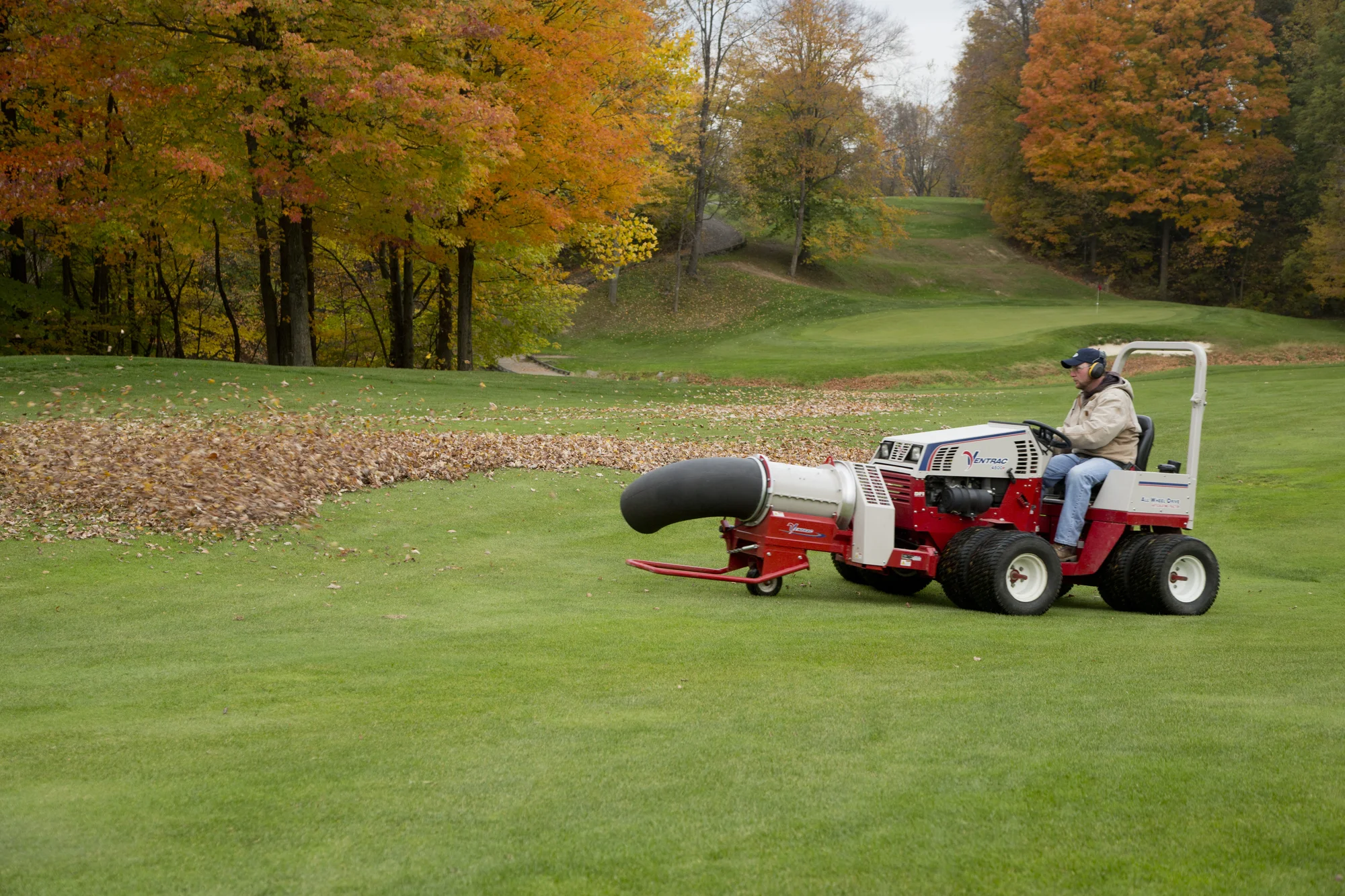 Ventrac P Series Compact Utility Tractors 4500P Side View Right Man Blowing Leaves product image