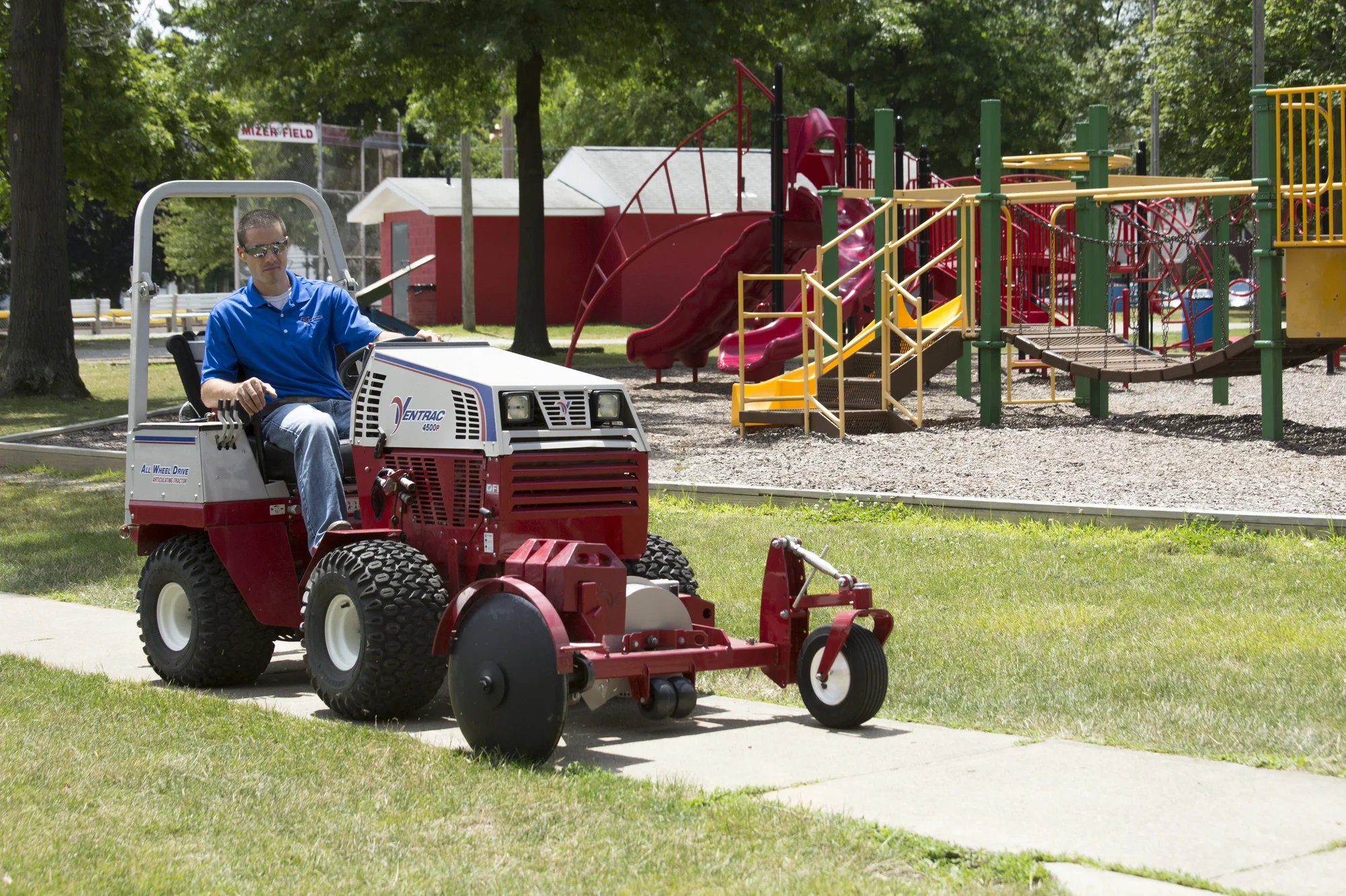 Ventrac P Series Compact Utility Tractors 4520P Front Left View Man Edging Sidewalk product image