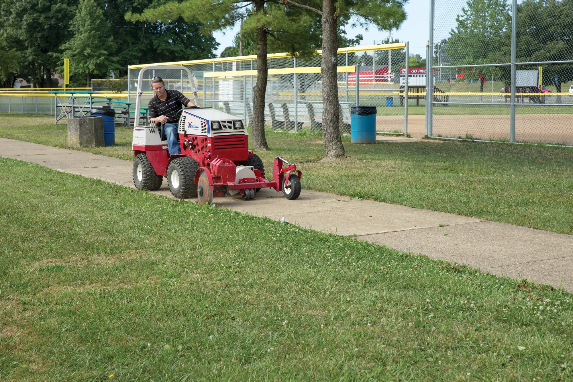 Ventrac 4520 Series Tractor 4520P Ventrac P Series Compact Utility Tractors 4520P Front View Left Edging Sidewalk product image