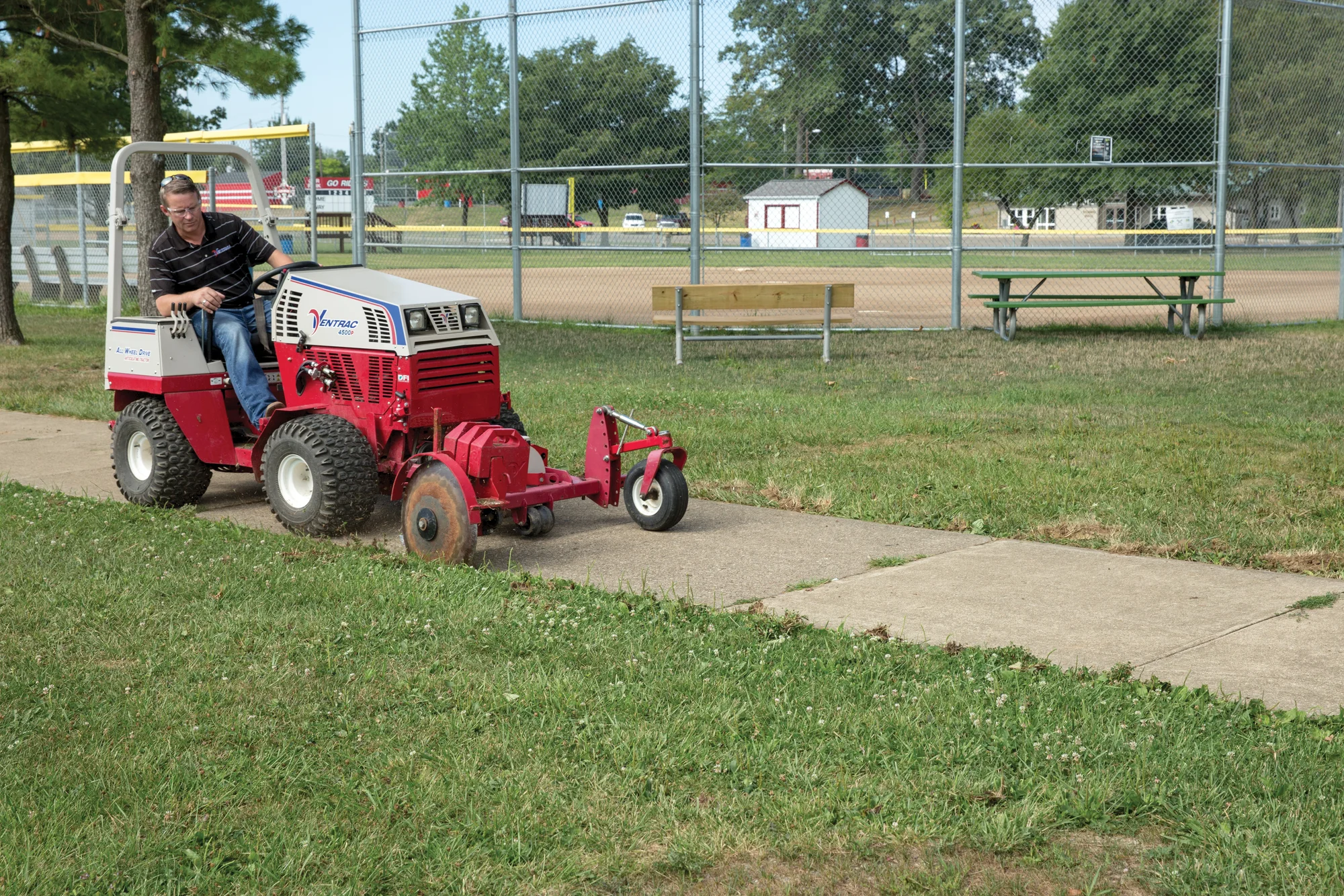 Ventrac 4520 Series Tractor 4520P Ventrac P Series Compact Utility Tractors 4520P Front View Left Edging Sidewalk Park product image