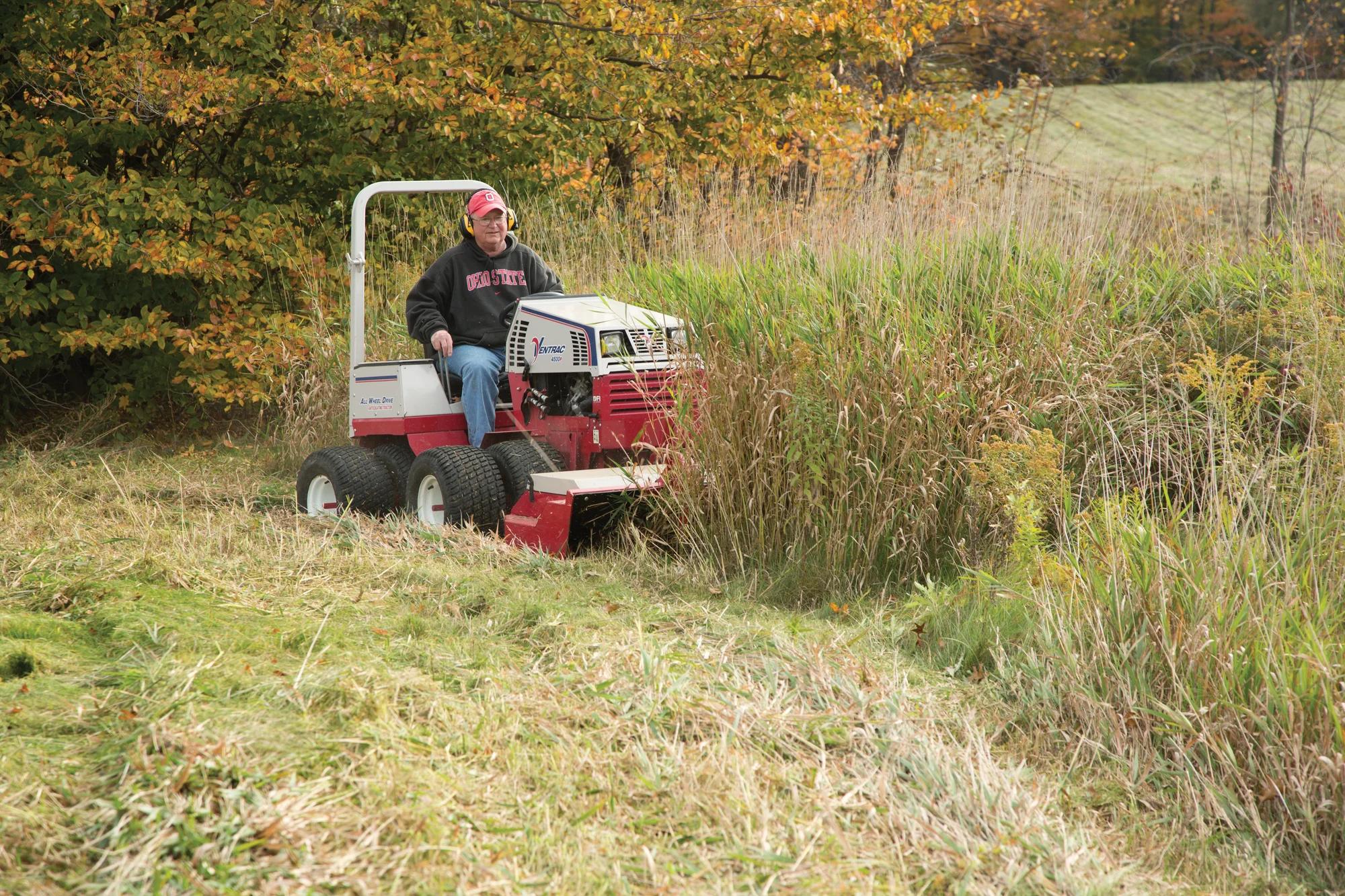 Ventrac 4520 Series Tractor 4520P Ventrac P Series Compact Utility Tractors 4520P Front View Left Mower Deck Cutting Tall Grass product image