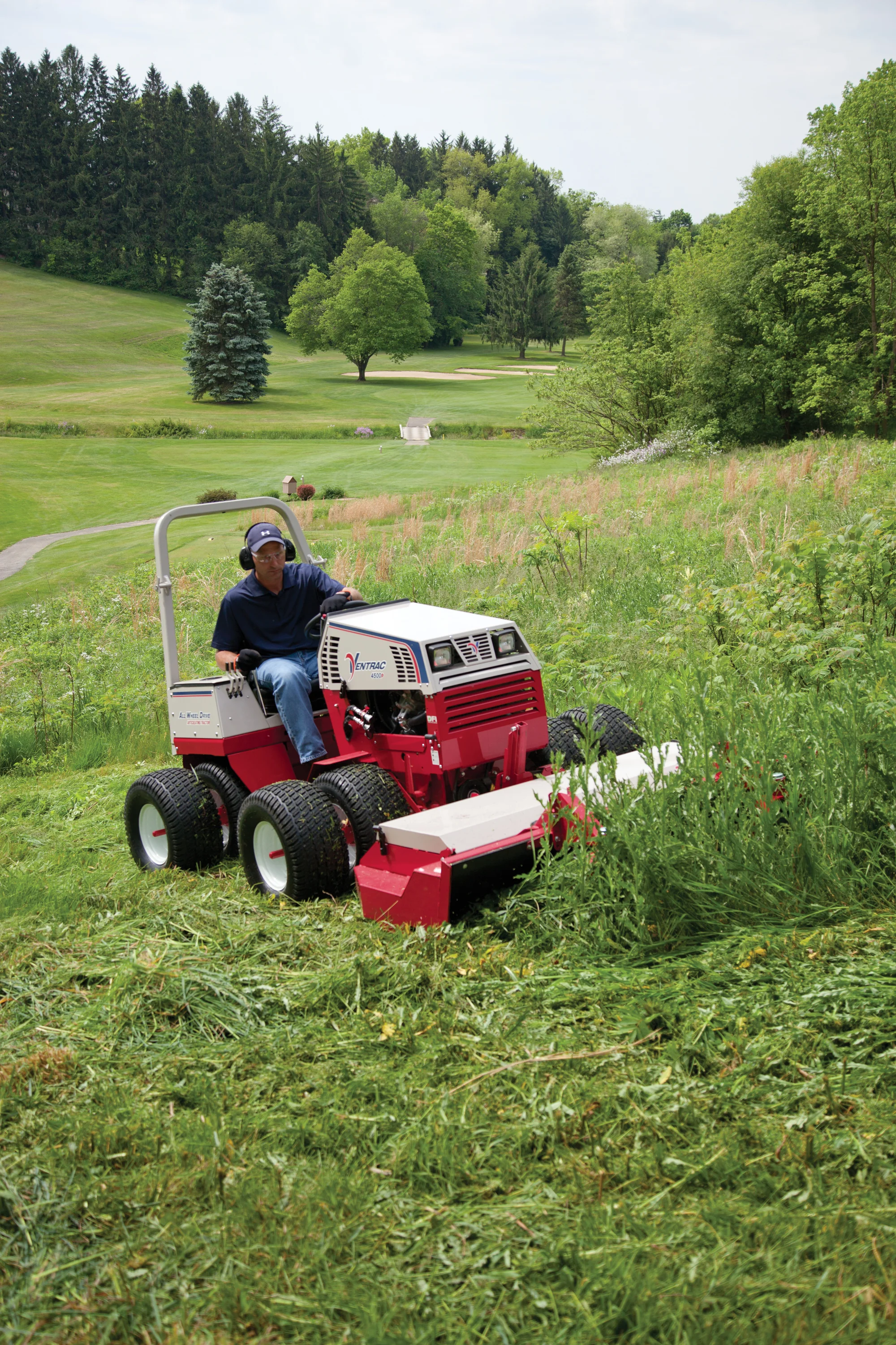 Ventrac 4520 Series Tractor 4520P Ventrac P Series Compact Utility Tractors 4520P Front View Left Mower Deck Cutting Weeds product image