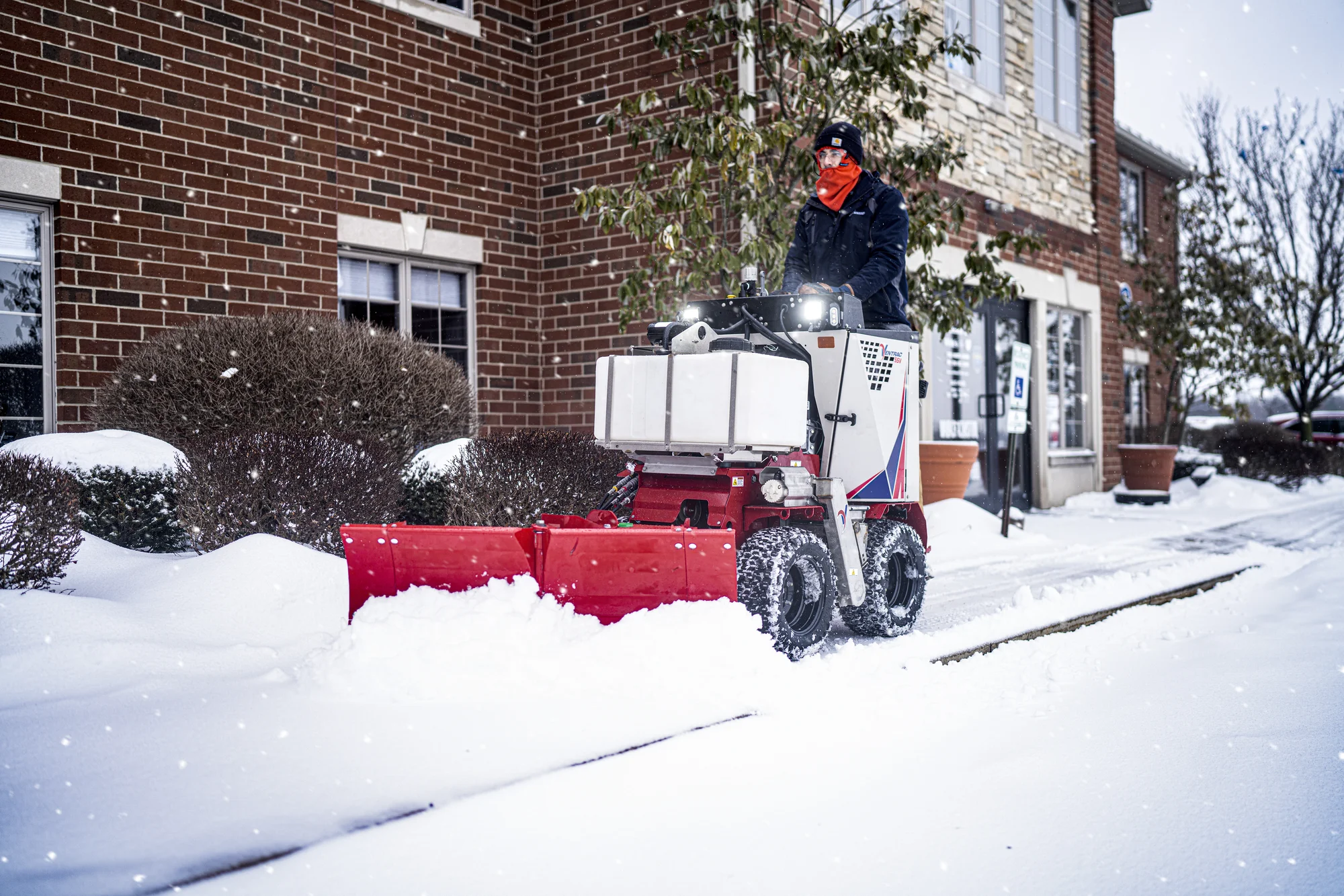 Ventrac SSV Sidewalk Snow Vehicle 2120M Ventrac Ssv Sidewalk Series Snow Vehicle 2120M Front View Right Man Clearing Sidewalk product image