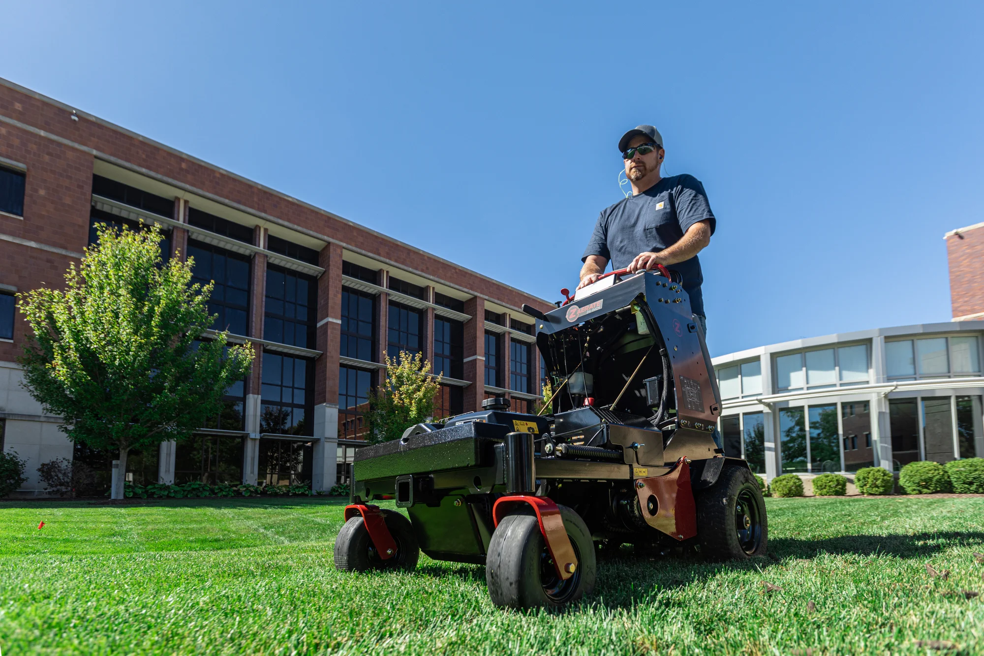 Z-Turf Z-Aerate 24 Stand-on Aerator ZA3624 Z Turf Z Aerate 24 Stand On Aerator Za3624 Front View Man On Equipment Low Wide Angle product image