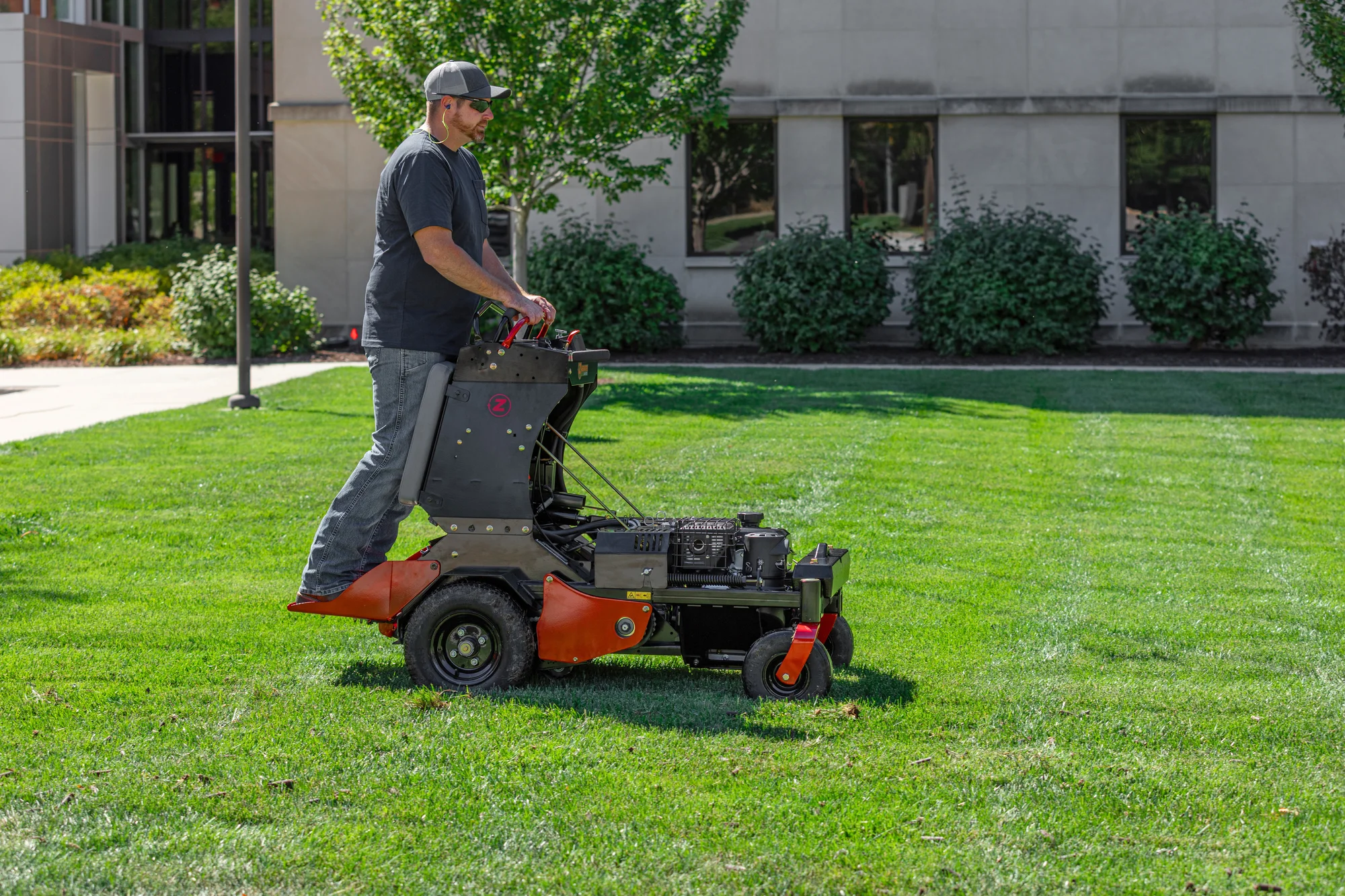 Z Turf Z Aerate 24 Stand On Aerator Za3624 Side View Man Aerating Grass product image